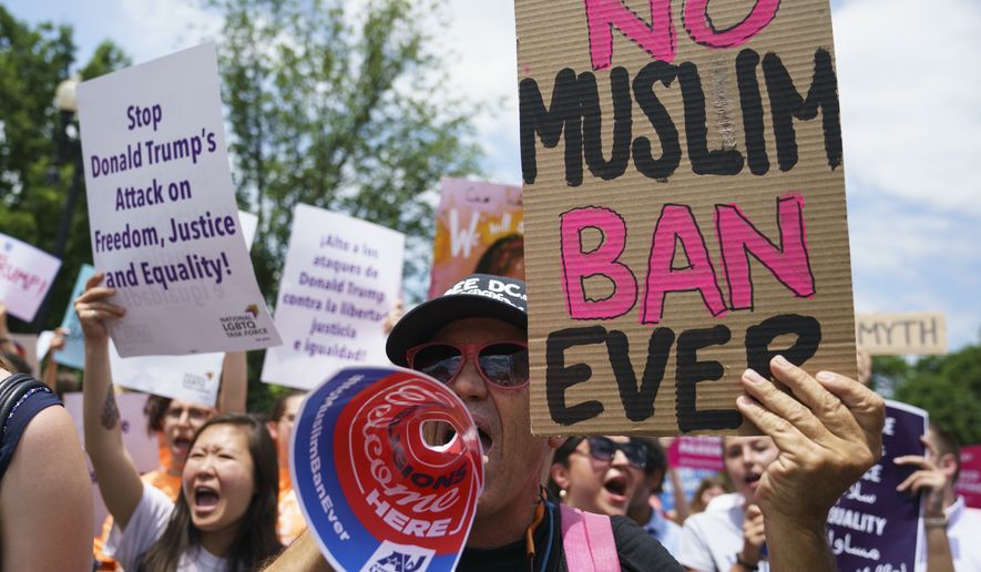 Protesters call out against the Supreme Court ruling upholding President Donald Trump&#39;s travel ban outside the Supreme Court on Capitol Hill in in Washington, Tuesday, June 26, 2018. (AP Photo/Carolyn Kaster)