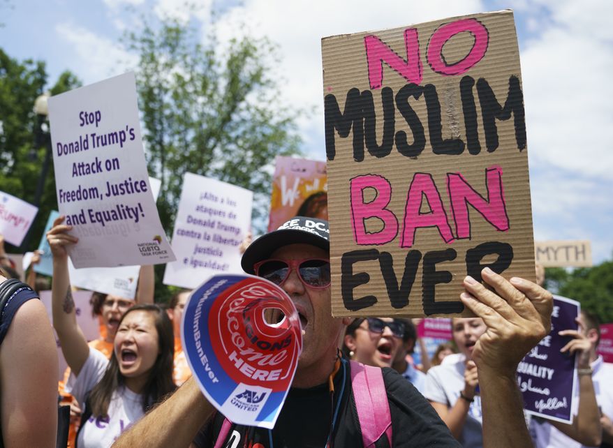 Protesters call out against the Supreme Court ruling upholding President Donald Trump&#39;s travel ban outside the Supreme Court on Capitol Hill in in Washington, Tuesday, June 26, 2018. (AP Photo/Carolyn Kaster)
