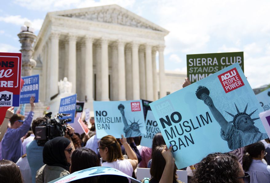 Protesters hold up signs and call out against the Supreme Court ruling upholding President Donald Trump&#39;s travel ban outside the the Supreme Court in Washington, Tuesday, June 26, 2018. (AP Photo/Carolyn Kaster)