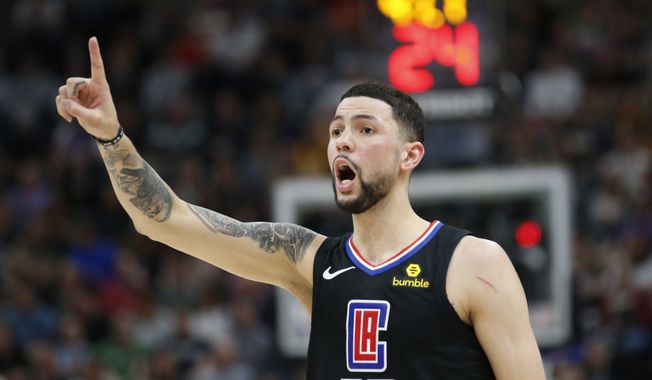 In this April 5, 2018, file photo, Los Angeles Clippers guard Austin Rivers shouts to his teammates during the first half of an NBA basketball game against the Utah Jazz in Salt Lake City. A person familiar with the deal says that the Washington Wizards have agreed to trade center Marcin Gortat to the Clippers for Rivers .(AP Photo/Rick Bowmer, File) **FILE**