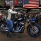 FILE - In this Dec. 12, 2017, file photo, Terri Meehan poses on a 2018 Harley Softail Slim in Milwaukee&#39;s House of Harley. Meehan took a riding course at the dealership as part of Harley-Davidson&#39;s &quot;Riding Academy,&quot; an initiative the company hopes will help bring new customers. Harley-Davidson, the iconic brand that sells its customers an image of freedom and adventure, found itself in an unwanted role this week: poster child for the damage of an international trade war. Harley said it would move production of motorcycles bound for Europe overseas, blaming European Union tariffs it said would add an estimated $2,200 cost to the average bike.(AP Photo/Ivan Moreno, File) **FILE**