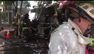 D.C. Fire rescue services deployed 80 firefighters to battle a two-alarm fire that started in Georgetown&#39;s popular eatery Wingos and spread to flower shop English Rose Garden on June 26, 2018. Flames injured three firefighters and caused &quot;considerable&quot; damage to the storefronts. (Photo courtesy of D.C. Fire and EMS)