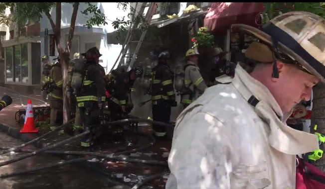 D.C. Fire rescue services deployed 80 firefighters to battle a two-alarm fire that started in Georgetown&#x27;s popular eatery Wingos and spread to flower shop English Rose Garden on June 26, 2018. Flames injured three firefighters and caused &quot;considerable&quot; damage to the storefronts. (Photo courtesy of D.C. Fire and EMS)