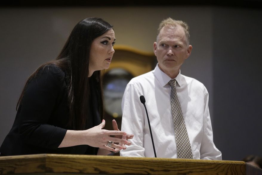 Julie Burns, director of the juvenile program that houses federal detained youths at the Yolo County Juvenile Detention Facility, discusses the program as Brent Cardall, the county's chief probation officer, looks on during a hearing of the Yolo County Board of Supervisors, Tuesday, June 26, 2018, in Woodland, Calif. The board voted to accept more than $2 million from the federal government to continue housing troubled older immigrant children at the facility. County officials say the youths are not among those separated from their families under a recent Trump administration policy. (AP Photo/Rich Pedroncelli)