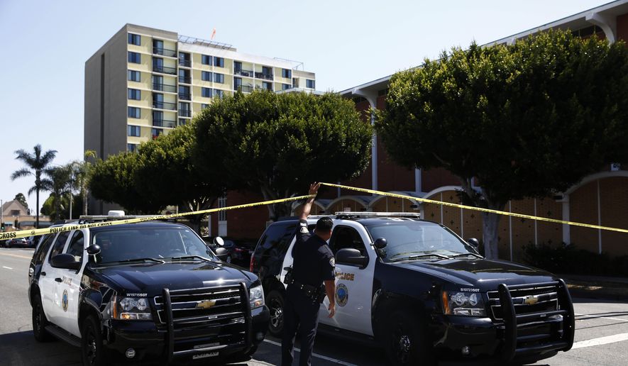 Long Beach police keep a street closed off on Monday, June 25, 2018, in Long Beach, Calif. Police said Saturday that an organized street fight resulted in two arrests and that a boy was shot in another incident after hordes of young people swarmed a shopping mall. (AP Photo/Jae C. Hong)