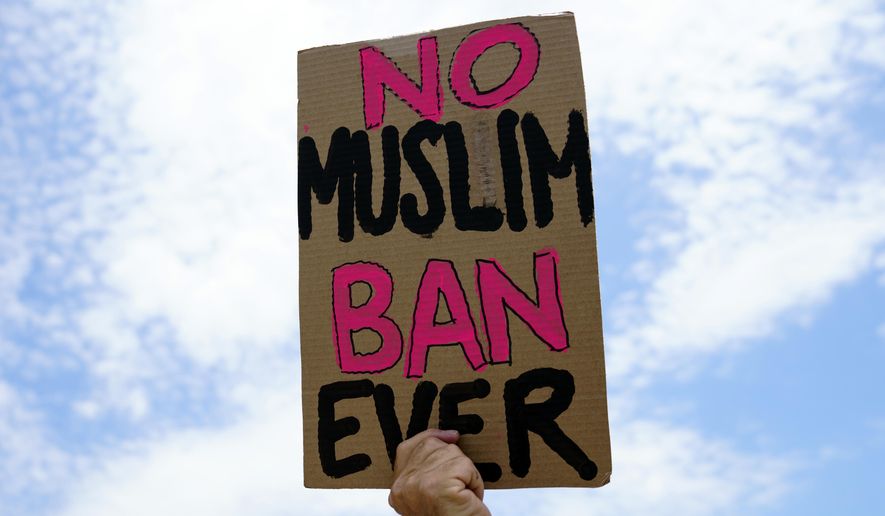 A protester holds up a sign that reads "No Muslim Ban Ever" as he protests against the Supreme Court ruling upholding President Donald Trump's travel ban outside the the Supreme Court in Washington, Tuesday, June 26, 2018. (AP Photo/Carolyn Kaster)