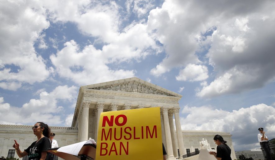 People protest against the Supreme Court ruling upholding President Donald Trump's travel ban outside the the Supreme Court in Washington, Tuesday, June 26, 2018. (AP Photo/Jacquelyn Martin)
