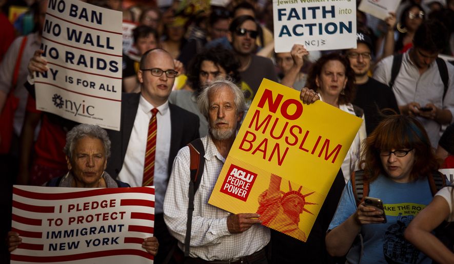 People protest during a rally about the U.S. Supreme Court&#x27;s decision to uphold President Donald Trump’s ban on travel from several mostly Muslim countries, Tuesday, June 26, 2018, in New York. Muslim individuals and groups, as well as other religious and civil rights organizations, expressed outrage and disappointment at the U.S. Supreme Court&#x27;s decision Tuesday to uphold President Donald Trump&#x27;s ban on travel from several mostly Muslim countries. (AP Photo/Andres Kudacki) ** FILE **