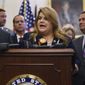 Puerto Rico&#39;s Resident Commissioner, Jenniffer González-Colón, speaks during a ceremony on Capitol Hill in Washington, Wednesday, June 27, 2018, to present the Puerto Rico Admission Act of 2018, a bill to chart Puerto Rico&#39;s transition from a territory to a State of the Union. She is joined by Puerto Rico Gov. Ricardo Rosselló, left, Rep. Don Bacon, R-Neb., right, and others (AP Photo/Carolyn Kaster)