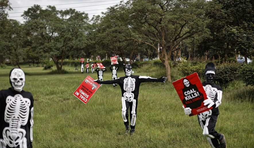 FILE - In this Tuesday, June 5, 2018 file photo, environmental protesters demonstrate against recent government plans to mine coal and open a coal-fired power plant, in downtown Nairobi, Kenya. Modest reductions in air pollution can prevent the deaths of tens of thousands of infants in sub-Saharan Africa each year, according to a new scientific study Wednesday, June 27, 2018. (AP Photo/Ben Curtis, File)