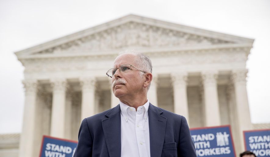 Plaintiff Mark Janus stands outside the Supreme Court after the court rules in a setback for organized labor that states can't force government workers to pay union fees, Wednesday, June 27, 2018, in Washington. (AP Photo/Andrew Harnik)