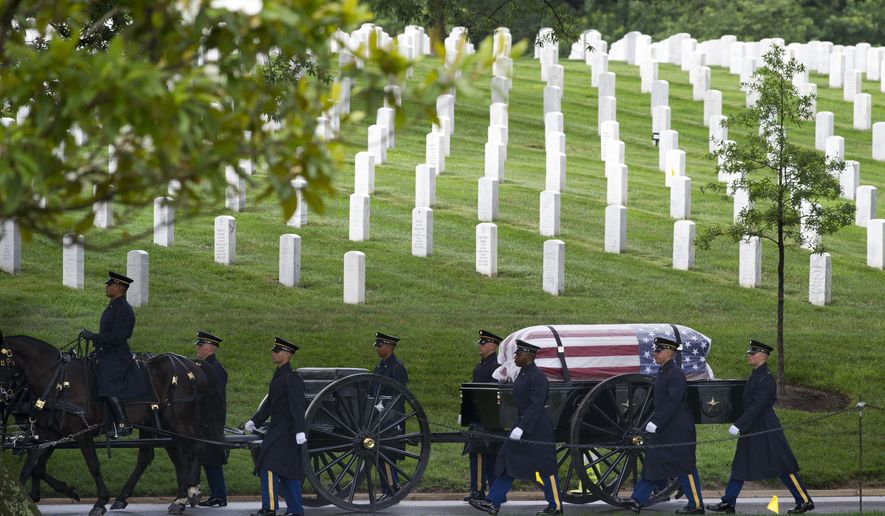 A caisson carries the casket containing the remains of five Army Air Forces crew members of a B-17 bomber shot down during a mission over Germany in World War II for a group burial at Arlington National Cemetery, in Arlington, Va., Wednesday, June 27, 2018. The crew members are; Tech. Sgt. John Brady, of Taunton, Mass.; Tech. Sgt. Allen Chandler Jr., of Fletcher, Okla.; 1st Lt. John Liekhus, of Anaheim, Calif.; Staff Sgt. Robert Shoemaker, of Takoma Park, Md.; and Staff Sgt. Bobby Younger, of McKinney, Texas. (AP Photo/Cliff Owen)