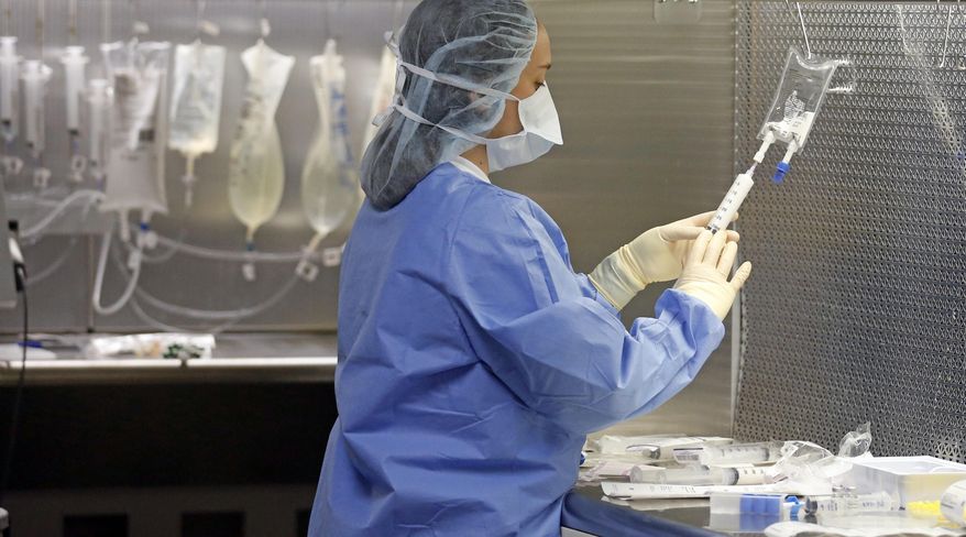 In this Friday, June 1, 2018, photo, a pharmacy technician prepares syringes containing fentanyl in the sterile medicines area of the inpatient pharmacy at the University of Utah Hospital, in Salt Lake City. Amid the nation's opioid epidemic, hospitals are struggling to get widely used injected pain medicines because of ongoing supply shortages. The shortages affect just about every corner of the hospital, from the operating room and emergency department. (AP Photo/Rick Bowmer)