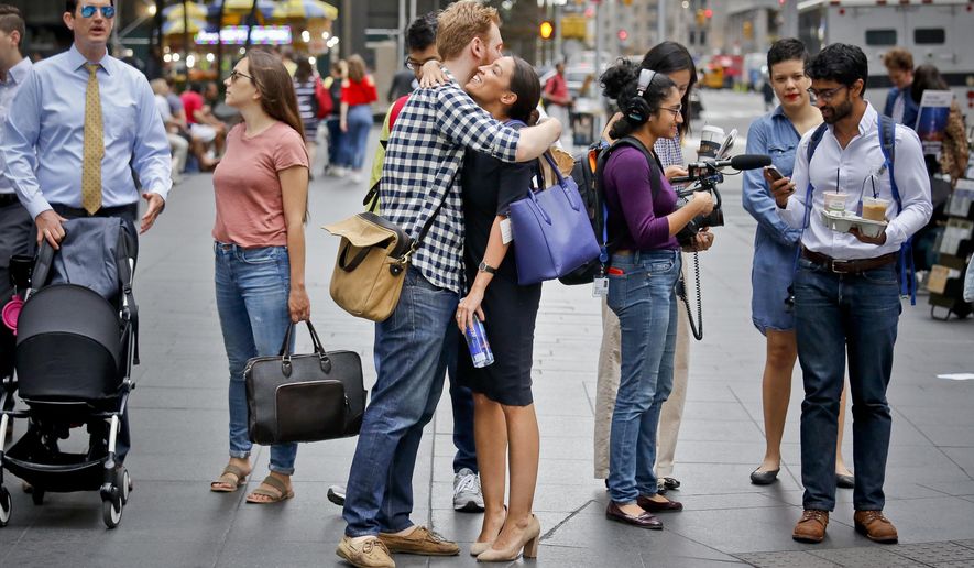 Alexandria Ocasio-Cortez, center, the winner of the Democratic primary victory in New York&#x27;s 14th Congressional District, hugs campaign volunteer Riley Roberts, Wednesday, June 27, 2018, in New York. Ocasio-Cortez, 28, upset U.S. Rep. Joe Crowley in Tuesday&#x27;s election, Wednesday June 27, 2018, in New York. (AP Photo/Bebeto Matthews)