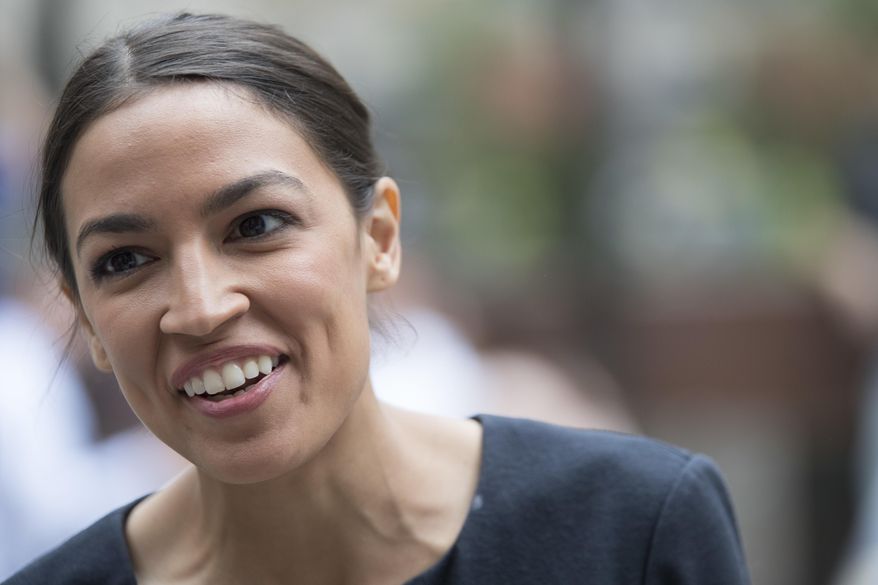 Alexandria Ocasio-Cortez, is photographed while being interviewed in Rockefeller Center, Wednesday, June 27, 2018, in New York. The 28-year-old political newcomer who upset U.S. Rep. Joe Crowley in New York's Democrat primary on Monday says she brings an "urgency" to the fight for working families. (AP Photo/Mary Altaffer)