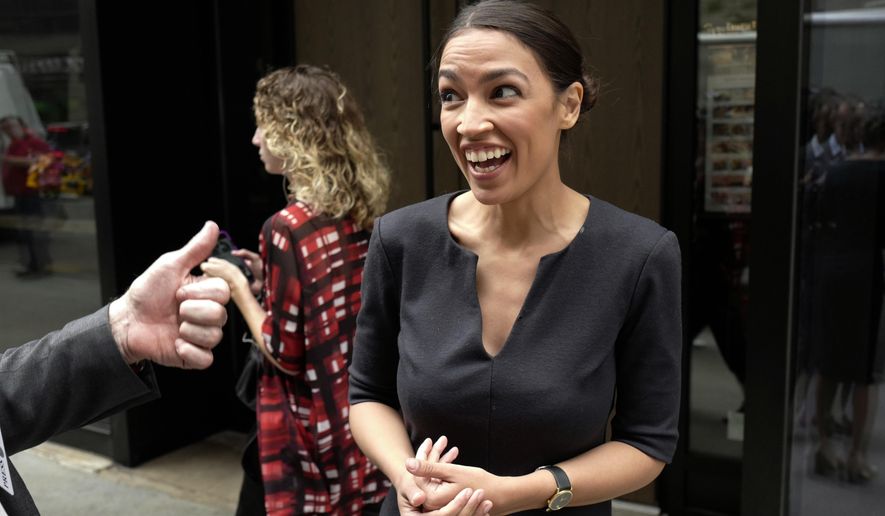 Alexandria Ocasio-Cortez, the winner of a Democratic Congressional primary in New York, reacts while talking to the media, Wednesday, June 27, 2018, in New York. Ocasio-Cortez, 28, upset U.S. Rep. Joe Crowley in Tuesday's election. (AP Photo/Mark Lennihan)