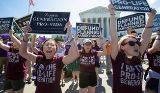Pro-life and anti-abortion advocates demonstrate in front of the Supreme Court early Monday, June 25, 2018. The justices are expected to hand down decisions today as the court&#39;s term comes to a close. (AP Photo/J. Scott Applewhite) **FILE**