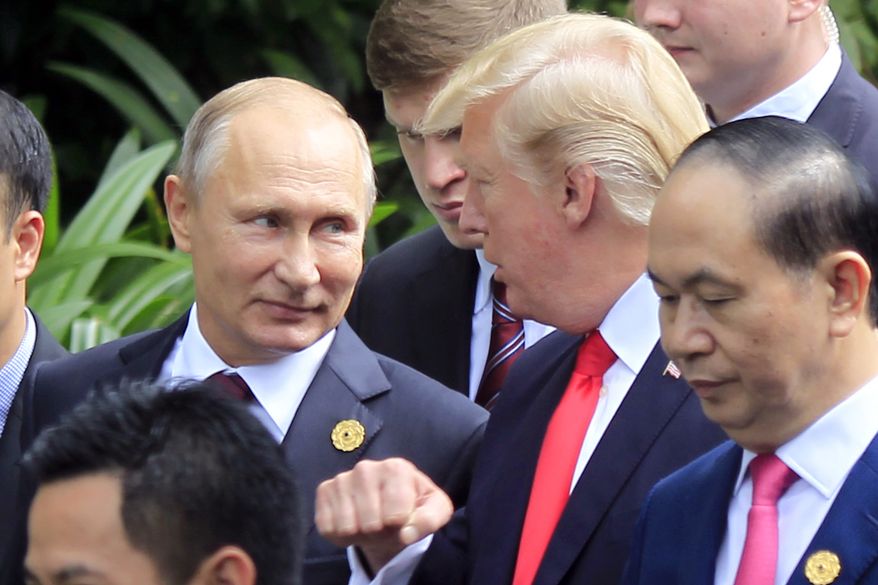 Russian President Vladimir Putin, left, and U.S. President Donald Trump talk as they arrive for the family photo session during the Asia-Pacific Economic Cooperation (APEC) Summit in Danang, Vietnam, Saturday, Nov. 11, 2017. President Trump stood before a summit of Asian leaders keen on regional trade pacts and delivered a roaring &quot;America first&quot; message Friday, denouncing China for unfair trade practices just a day after he had heaped praise on President Xi Jinping in Beijing. (AP Photo/Hau Dinh)