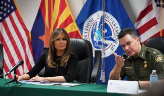 First lady Melania Trump talks with Rodolfo Karisch, Chief Patrol Agent, Tucson Sector Border Patrol, as she visits a U.S. Customs border and protection facility in Tucson, Ariz., Thursday, June 28, 2018. (AP Photo/Carolyn Kaster)