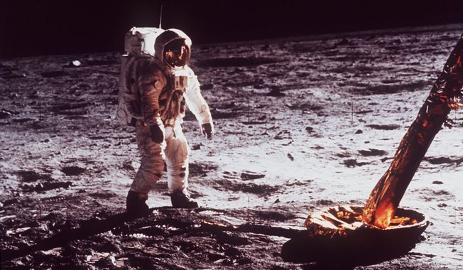 Astronaut Edwin &quot;Buzz&quot; Aldrin walks by the footpad of the Apollo 11 Lunar Module, July 1969. (AP Photo/NASA)