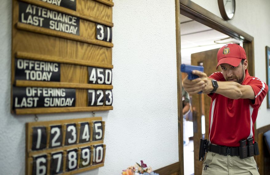 Lead Senior Firearms instructor at Georgia Firearms and Security Training Academy, Apollos Stanek, leads an exercise on how to clear a room at Calvary Baptist Church in New Stanton, Pa., on Friday, June 22, 2018. Representatives from 13 area churches got tips last week on proper handling of guns in the event any of their congregations faces a deadly intruder. In an age when any house of worship might become a gunman's target, the 17 men who gathered at Calvary Baptist Church in New Stanton practiced the best grip and stance to use when aiming a handgun. (Carolyn Rogers/Pittsburgh Tribune-Review via AP)