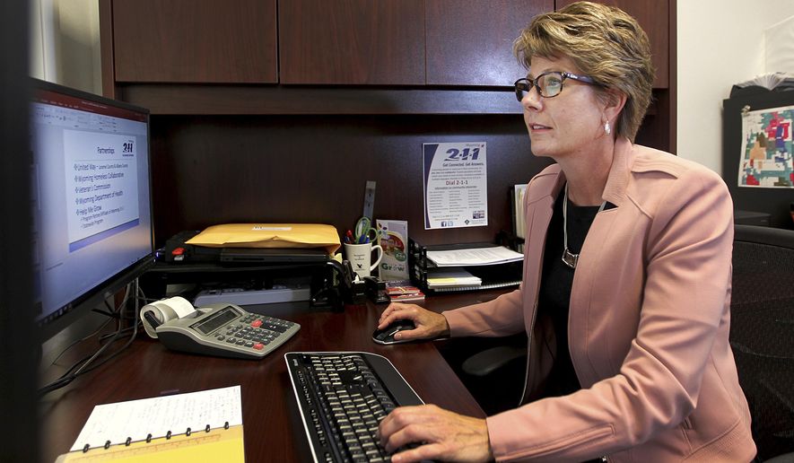 In this June 22, 2018, photo, the executive director for Wyoming 2-1-1, Sabrina Lane, poses for a portrait in her office in Cheyenne, Wyo. Lane plans to increase the organization's visibility and diversify its funding opportunities in the coming years. (Jacob Byk/The Wyoming Tribune Eagle via AP)