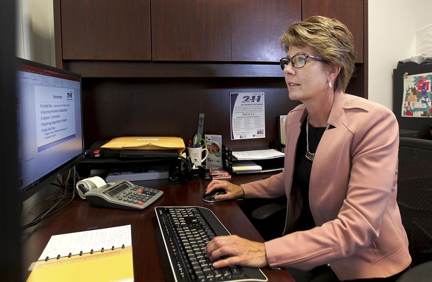 In this June 22, 2018, photo, the executive director for Wyoming 2-1-1, Sabrina Lane, poses for a portrait in her office in Cheyenne, Wyo. Lane plans to increase the organization's visibility and diversify its funding opportunities in the coming years. (Jacob Byk/The Wyoming Tribune Eagle via AP)