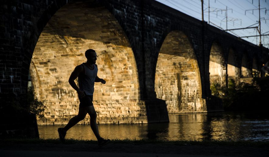 In this Wednesday, Oct. 4, 2017, file photo, a man runs along the Schuylkill River on Kelly Drive in Philadelphia. (AP Photo/Matt Rourke)