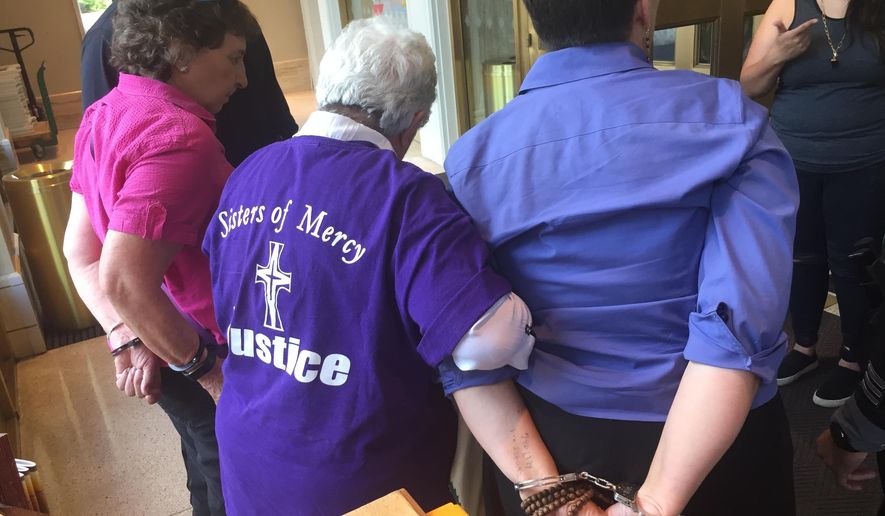 Eleanor Chavez, left, Marlene Perrotte, center, and Susan Schuurman, right, are arrested by New Mexico State Police at the Capitol in Santa Fe, N.M., on Thursday, June 28, 2018. Protesters from faith-based groups gathered to condemn Republican New Mexico Gov. Susana Martinez's support for federal immigration policies and ignored requests to leave as the building was closed to visitors. Martinez was traveling in Taiwan. (AP Photo/Morgan Lee)