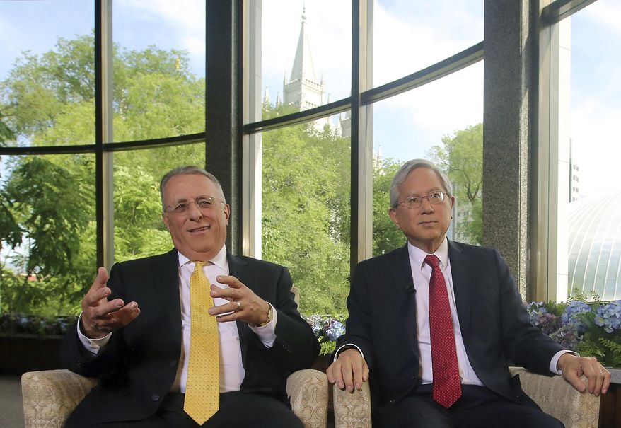 The two newest members of a top Mormon governing panel, Ulisses Soares, left, and Gerrit W. Gong, right, speak on Thursday, June 28, 2018, in Salt Lake City, during their first media interviews since being selected to the religion's Quorum of the Twelve Apostles earlier this year. Soares and Gong made history by becoming the first-ever Latin-American and the first-ever person of Asian ancestry on the previously all-white top leadership panel that help make policy decisions for The Church of Jesus Christ of Latter-day Saints. (AP Photo/Rick Bowmer)