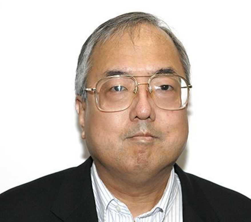 FILE -This July, 2015 file photo shows Eugene Kim, longtime broadcast writer and editor for The Associated Press. For 34 years, Kim was the writer of the daily Today in History feature that was used by AP broadcasters and newspapers around the country. Kim has died at the age of 61. (AP Photo)