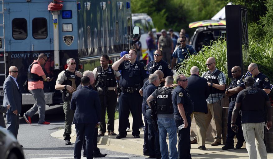 Police secure the scene of a shooting in Annapolis, Md., Thursday, June 28, 2018. A single shooter killed several people Thursday and wounded others at a newspaper in Annapolis, Maryland, and police said a suspect was in custody. (AP Photo/Susan Walsh)