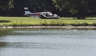 In this photo released by Alexander Piela a small plane is seen on the Assateague Greens Golf Course, Friday, June 29, 2018, in Berlin, Md. Ryan Whittington of the Ocean City Fire Department said personnel rushed to the scene and requested multiple ambulances for serious injuries. Smoke was reported coming from the plane. (Alexander Piela via AP)