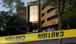 Crime scene tape surrounds a building housing The Capital Gazette newspaper&#39;s offices, Friday, June 29, 2018, in Annapolis, Md. A man armed with smoke grenades and a shotgun attacked journalists in the building Thursday, killing several people before police quickly stormed the building and arrested him, police and witnesses said. (AP Photo/Patrick Semansky) ** FILE **