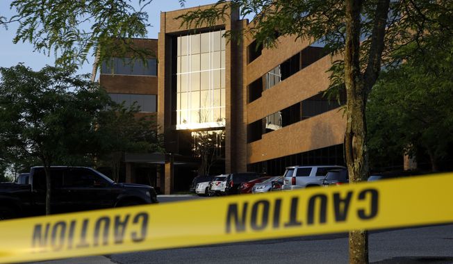 Crime scene tape surrounds a building housing The Capital Gazette newspaper&#x27;s offices, Friday, June 29, 2018, in Annapolis, Md. A man armed with smoke grenades and a shotgun attacked journalists in the building Thursday, killing several people before police quickly stormed the building and arrested him, police and witnesses said. (AP Photo/Patrick Semansky) ** FILE **
