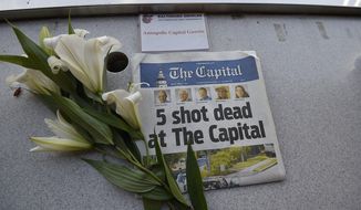 A memorial for Capital Gazette sports writer John McNamara is displayed at a seat in the press box before a baseball game between the Baltimore Orioles and the Los Angeles Angels, Friday, June 29, 2018, in Baltimore. McNamara is one of five victims in a  shooting in the newspaper&#39;s newsroom Thursday in Annapolis, Md. (AP Photo/Gail Burton)