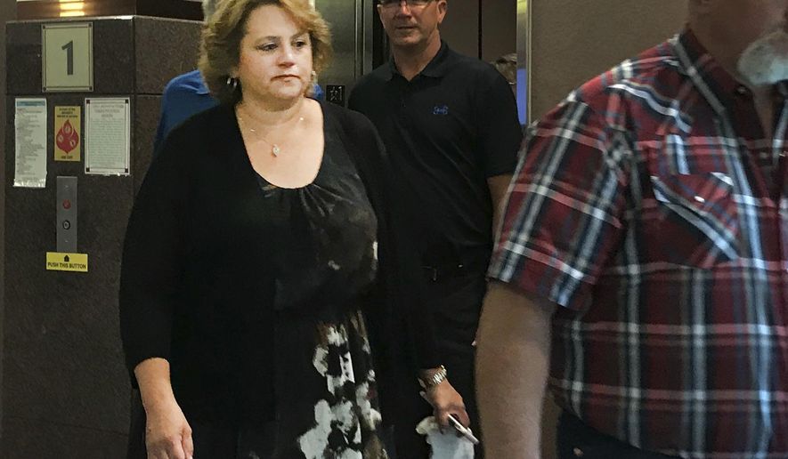 Stephanie Hubers, left, leaves the Minnehaha County Clerk-Courts Thursday, June 28, in Sioux Falls, S.D.  A jury is considering the case of the former South Dakota educational cooperative employee accused in an embezzlement scheme uncovered after a family&#x27;s death. Closing arguments were Friday in the theft trial of Stephanie Hubers. She&#x27;s a onetime Mid-Central Educational Cooperative staffer accused of receiving about $55,000 to keep quiet about embezzlement by business manager Scott Westerhuis and his wife before they perished in a 2015 murder-suicide.  (Dana Ferguson /The Argus Leader via AP)