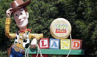 In this Saturday, June 23, 2018 photo, a statue of the character Sheriff Woody greets visitors at the entrance Toy Story Land in Disney&#x27;s Hollywood Studios at Walt Disney World in Lake Buena Vista, Fla. (AP Photo/John Raoux)