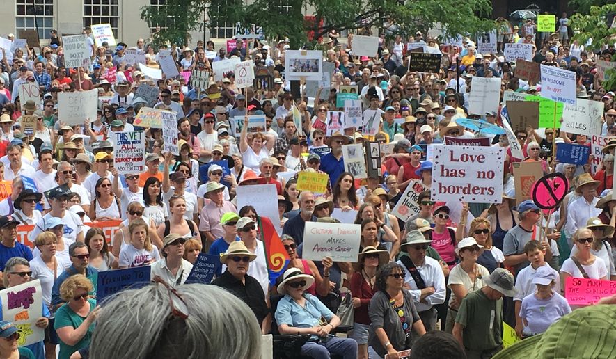 About 2,000 people protest Trump administration immigration policies outside City Hall in Portland, Maine, on Saturday, June 30, 2018. (AP Photo/David Sharp)
