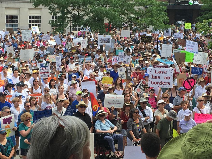 About 2,000 people protest Trump administration immigration policies outside City Hall in Portland, Maine, on Saturday, June 30, 2018. (AP Photo/David Sharp)