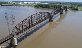 In this photo made Wednesday, June 27, 2018, the Merchants Bridge crosses the Mississippi River in St. Louis. The 127-year-old railroad bridge is in danger of being shut down if it is not replaced soon, but officials are struggling with how to pay for a planned repair and the 12,500 tons of steel the project would require after tariffs were recently enacted. (AP Photo/Jeff Roberson)