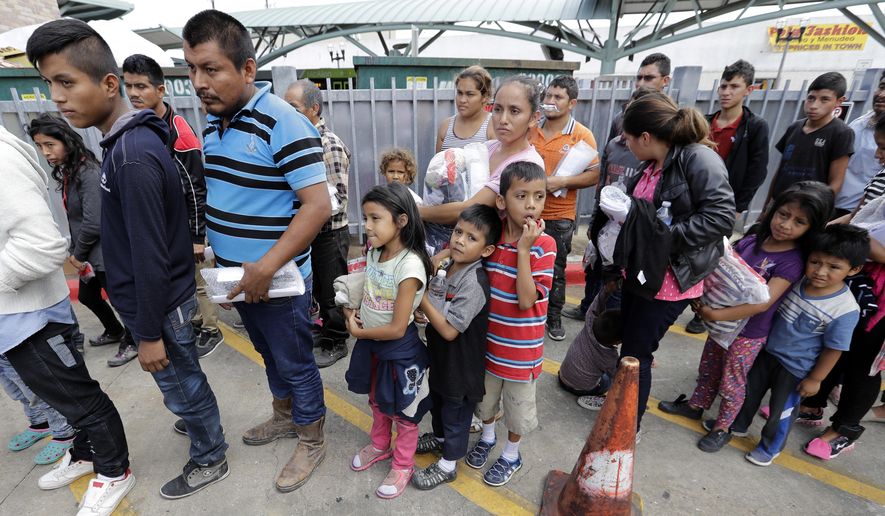 Immigrant families lined up to enter the central bus station after they were processed and released by U.S. Customs and Border Protection last month in McAllen, Texas. (Associated Press/File)