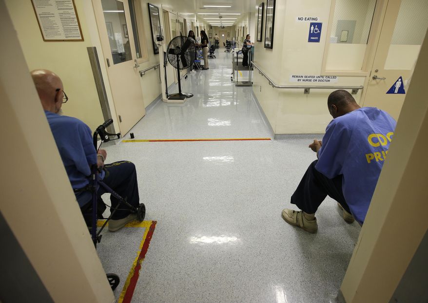 In this photo taken June 20, 2018, a pair of inmates wait for medical treatment at the California Medical Facility in Vacaville, Calif. CMF is one of the California prisons where general population inmates are expected to peacefully co-exist alongside inmates formerly housed on so-called Sensitive Needs Yards. The protective yards were created to safeguard gang snitches, disgraced cops, child molesters and others in need of protective custody. But they have become so violent and crowded that officials are dismantling the program (AP Photo/Rich Pedroncelli)