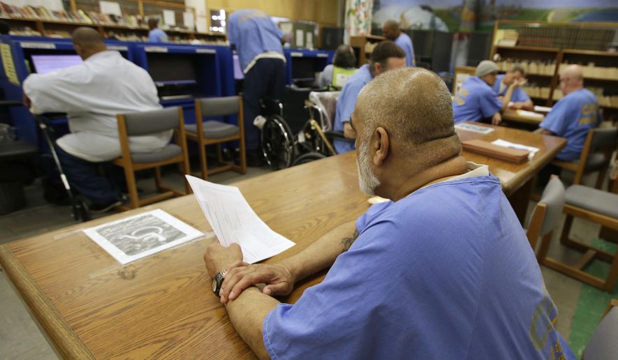 In this file photo taken June 20, 2018, inmates use the library at the California Medical Facility in Vacaville, Calif. . (AP Photo/Rich Pedroncelli) **FILE**
