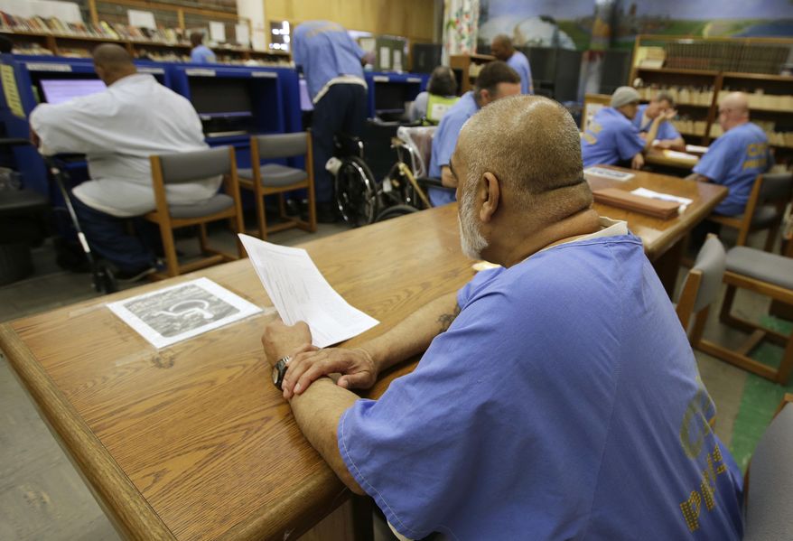 In this file photo taken June 20, 2018, inmates use the library at the California Medical Facility in Vacaville, Calif. . (AP Photo/Rich Pedroncelli) **FILE**