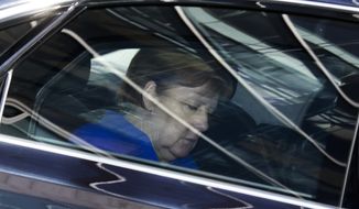 German Chancellor Angela Merkel and chairwoman of the Christian Democratic Union party leaves the headquarters after a board meeting in Berlin, Monday, July 2, 2018. (AP Photo/Markus Schreiber)