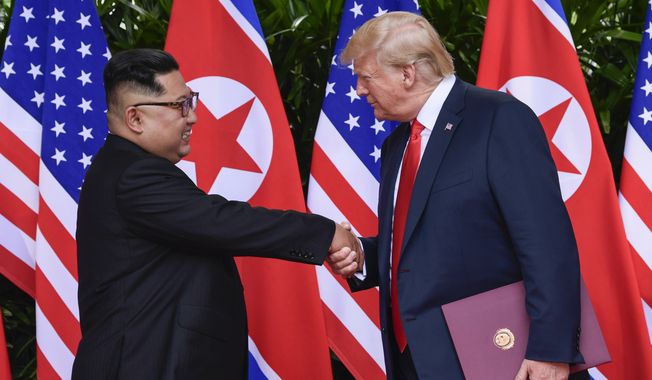 In this June 12, 2018, file photo, North Korea leader Kim Jong-un, left, and U.S. President Donald Trump shake hands at the conclusion of their meetings at the Capella resort on Sentosa Island in Singapore. (AP Photo/Susan Walsh, Pool, File)