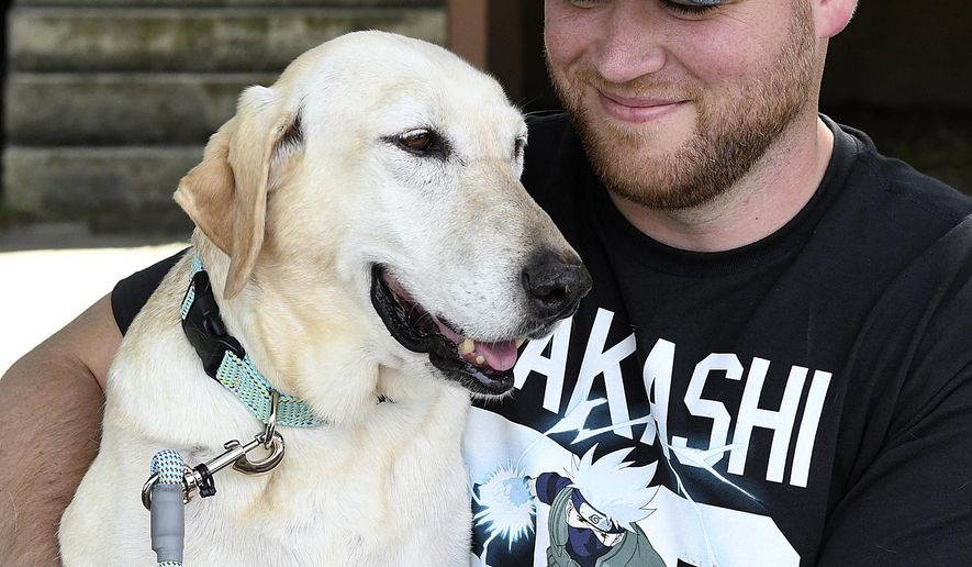 Seven years ago, Marine Nick Montez was unexpectedly ripped away from his bomb-sniffing dog Mally after returning from deployment in Afghanistan. Tuesday, June 26, 2018, he brought Mally home to Lewiston. (Pete Caster/Lewiston Tribune via AP)