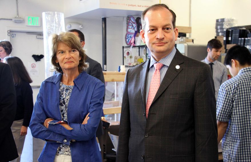 U.S. Sen. Lisa Murkowski, left, and Labor Secretary Alexander Acosta, right, tour the Cook Inlet Tribal Council Employment and Training Center on Monday, July 2, 2018, in Anchorage, Alaska. Acosta is traveling in Alaska this week, and said during a Sunday stop in Fairbanks that Alaska's economy should pick up given an increase in military spending and pro-energy policies of the Trump administration. (AP Photo/Mark Thiessen)