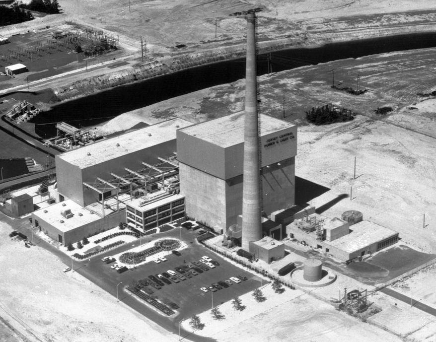 FILE - This July 12, 1972 file photo shows the Oyster Creek nuclear power plant in Lacey Township, N.J. Federal regulators say America’s oldest nuclear power plant will shut down Sept. 17, 2018, and plans to have its reactor fuel placed into dry storage within about six years. But the Oyster Creek plant, which opened in 1969, will remain in Lacey Township, New Jersey, until nearly the end of this century. (AP Photo, File)